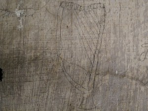 A harp drawn with pencil over whitewash located in a cell on Corridor 2 of the Top Floor with a reference to 'DeValera' referenced within.
