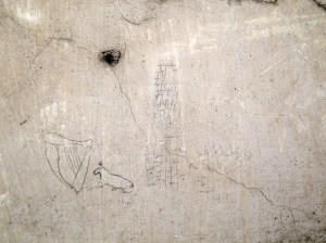 Collection of 'Irish' symbols including round tower and harp located in cell on Corridor 1 of Top Floor.